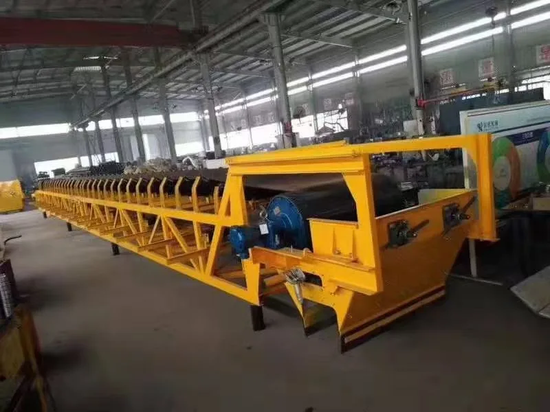 Yellow steel conveyor frame and drive assembly in a workshop