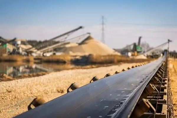 Belt conveyor beside aggregate stockpiles